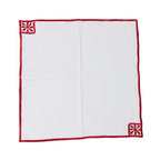 White handkerchief with red border and corner designs on a white background