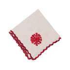 White napkin with red trim and floral design